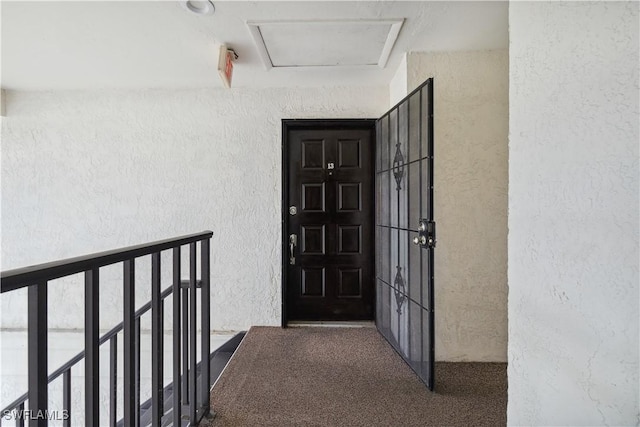 entrance to property featuring stucco siding
