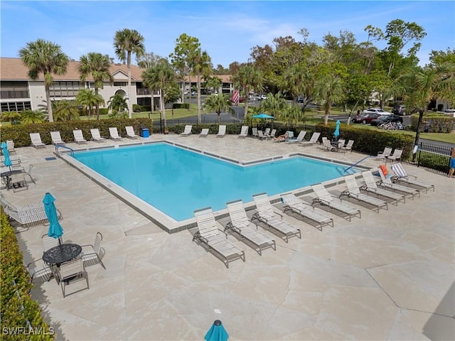 pool featuring a patio and fence