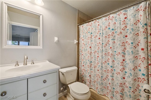 bathroom featuring vanity, toilet, and a shower with shower curtain