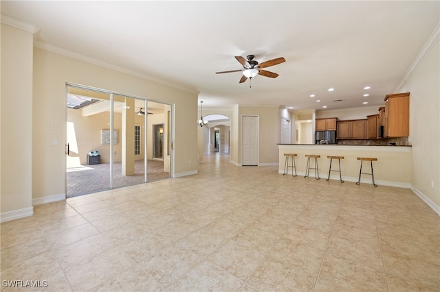 unfurnished living room featuring ceiling fan, crown molding, arched walkways, recessed lighting, and light tile patterned flooring