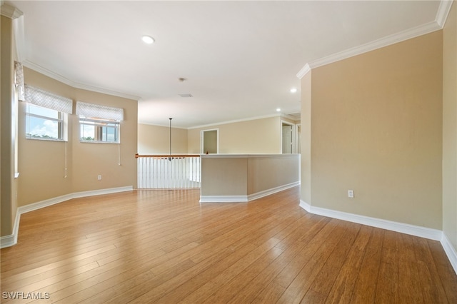 unfurnished room with light wood finished floors, ornamental molding, baseboards, and recessed lighting