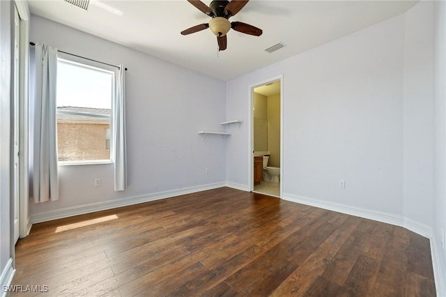 empty room featuring hardwood / wood-style floors, a ceiling fan, and baseboards