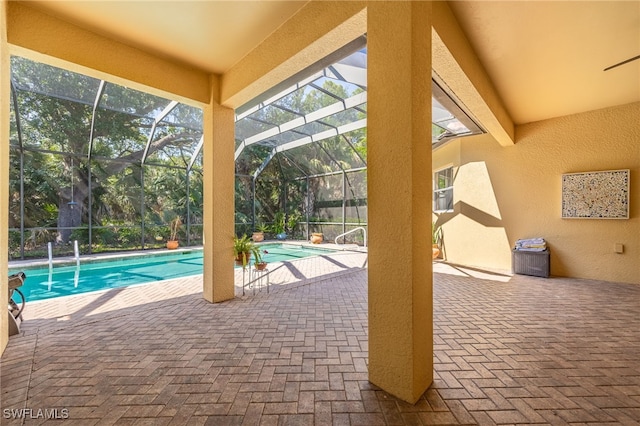 swimming pool with a patio and glass enclosure