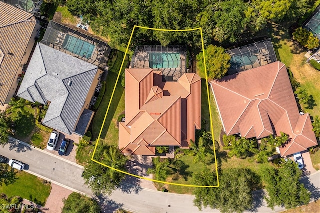 aerial overview of property's location with property parcel outlined and a pool