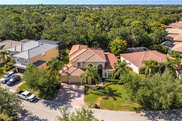 aerial view of residential area featuring a heavily wooded area