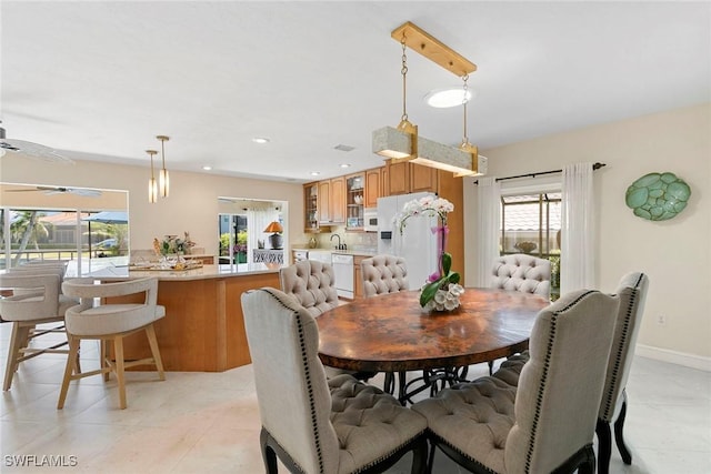 dining area featuring healthy amount of natural light, baseboards, and recessed lighting