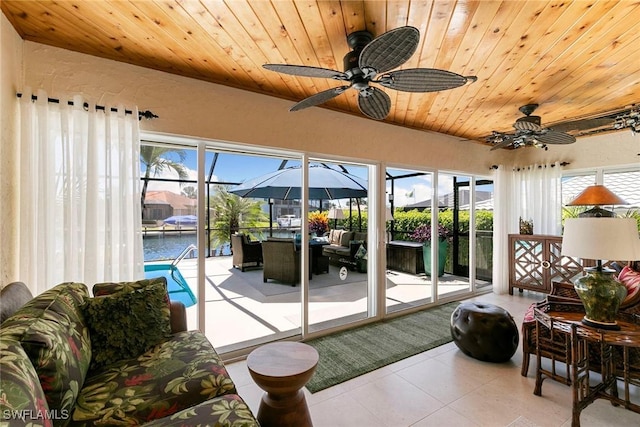 sunroom featuring a water view