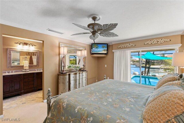 carpeted bedroom featuring crown molding, access to outside, ensuite bathroom, a sink, and ceiling fan