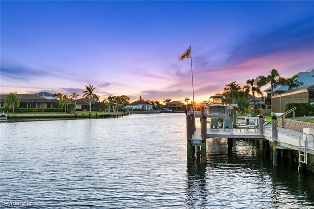dock area with a residential view, a water view, and boat lift