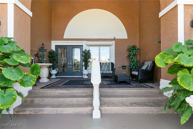 property entrance with french doors and stucco siding