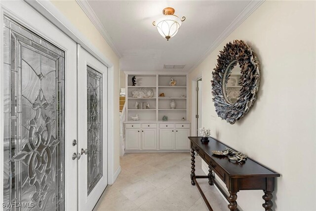 entryway with built in features and crown molding