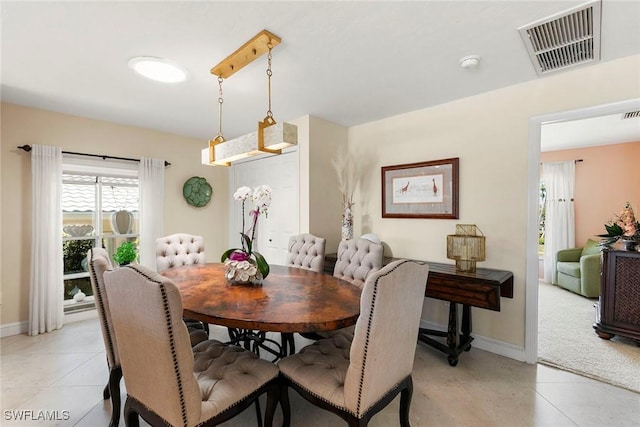 dining space with baseboards and light tile patterned flooring