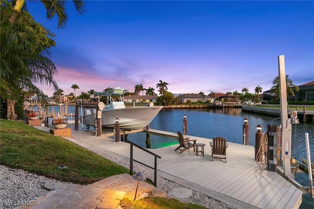 dock area featuring boat lift and a water view