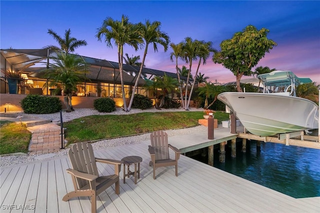 dock area featuring boat lift and a lanai