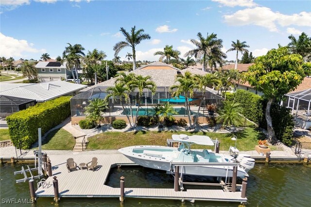 dock area featuring boat lift, a water view, glass enclosure, and a residential view