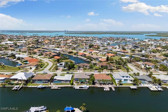 aerial view of residential area featuring a nearby body of water