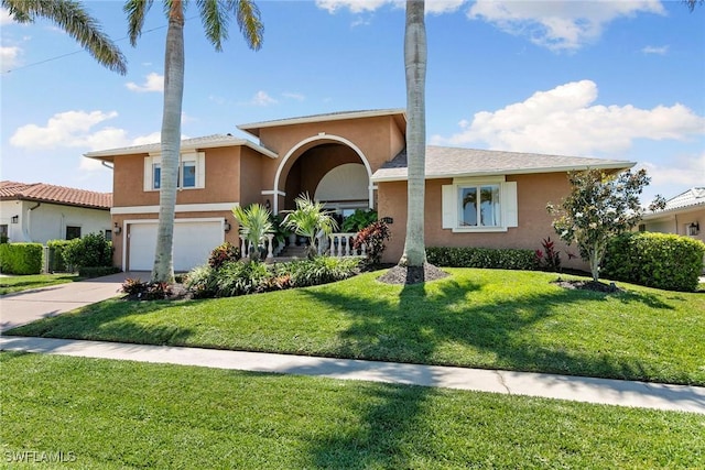 view of front of property featuring stucco siding, a garage, concrete driveway, and a front yard