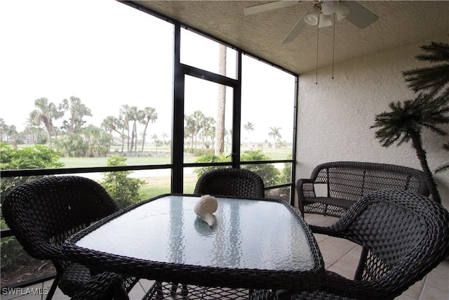 sunroom / solarium with ceiling fan and outdoor dining space