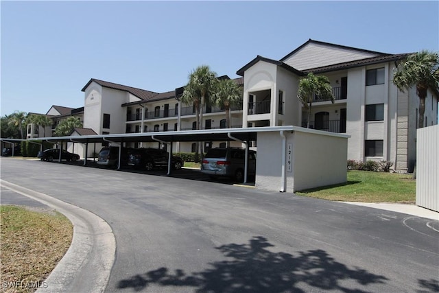 view of front of property featuring covered parking and stucco siding