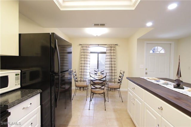 kitchen with wooden counters, white microwave, plenty of natural light, recessed lighting, and baseboards
