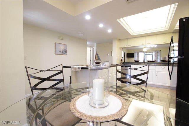 dining space with recessed lighting and a skylight