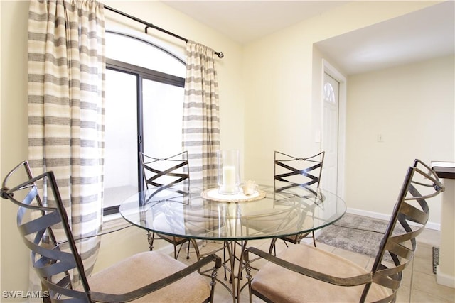 dining space with tile patterned floors and baseboards