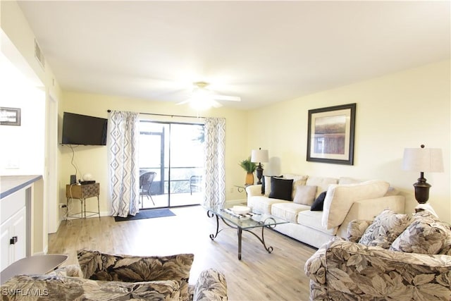 living area featuring light wood-type flooring and ceiling fan