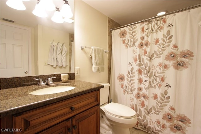bathroom with vanity, toilet, and curtained shower