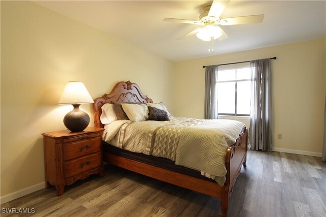 bedroom with baseboards, wood finished floors, and ceiling fan