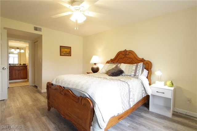bedroom featuring baseboards, light wood-type flooring, and a ceiling fan