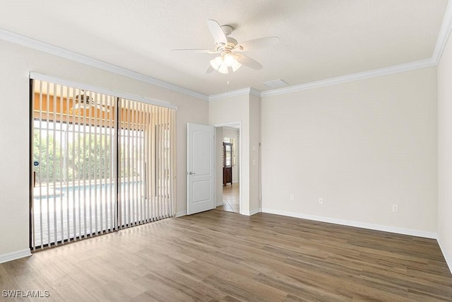 unfurnished room featuring plenty of natural light, wood finished floors, a ceiling fan, baseboards, and ornamental molding