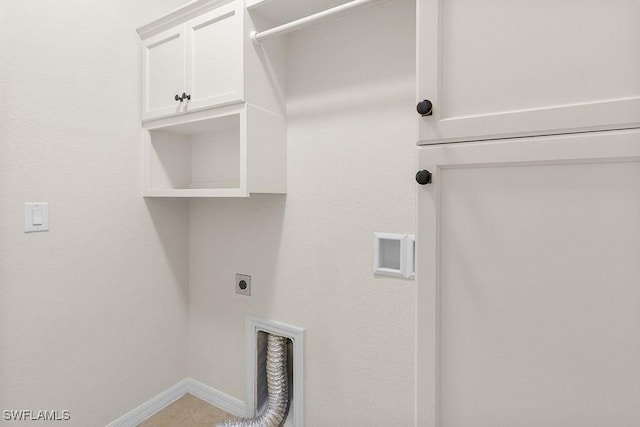 washroom featuring hookup for an electric dryer, cabinet space, and baseboards