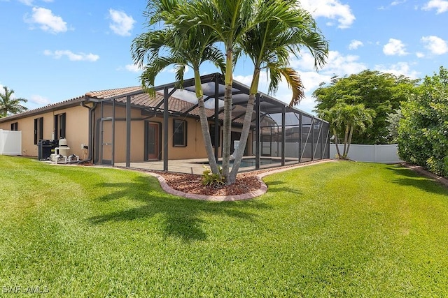 back of house with stucco siding, a patio area, a lanai, and an outdoor pool