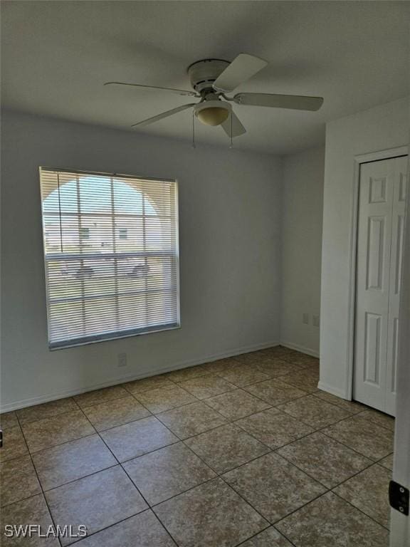 417 NW 18th Pl, Cape Coral, FL 33993 - tiled spare room featuring baseboards and a ceiling fan