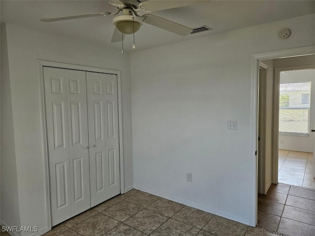 417 NW 18th Pl, Cape Coral, FL 33993 - unfurnished bedroom with a ceiling fan, a closet, baseboards, visible vents, and tile patterned floors