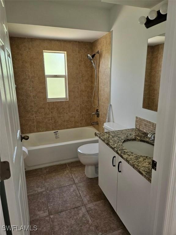 417 NW 18th Pl, Cape Coral, FL 33993 - bathroom featuring vanity, toilet, tub / shower combination, and tile patterned floors