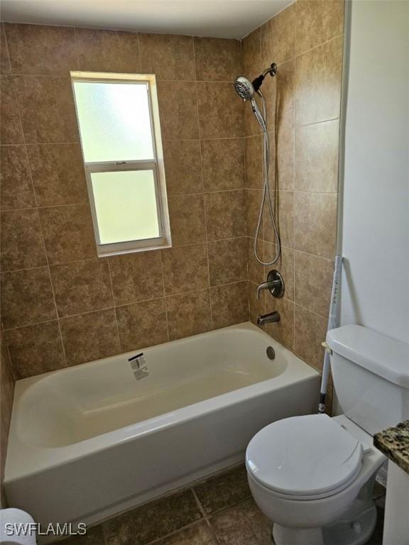417 NW 18th Pl, Cape Coral, FL 33993 - full bath featuring toilet, tile patterned flooring, and bathing tub / shower combination