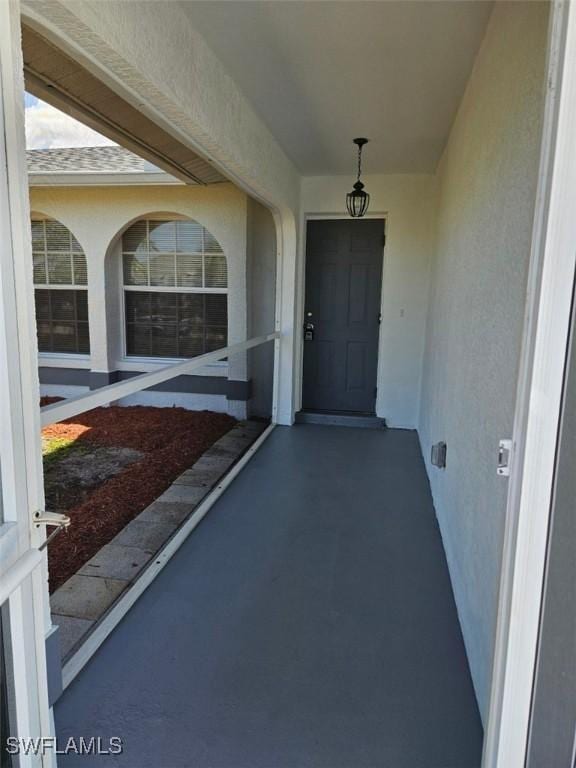 417 NW 18th Pl, Cape Coral, FL 33993 - doorway to property featuring stucco siding