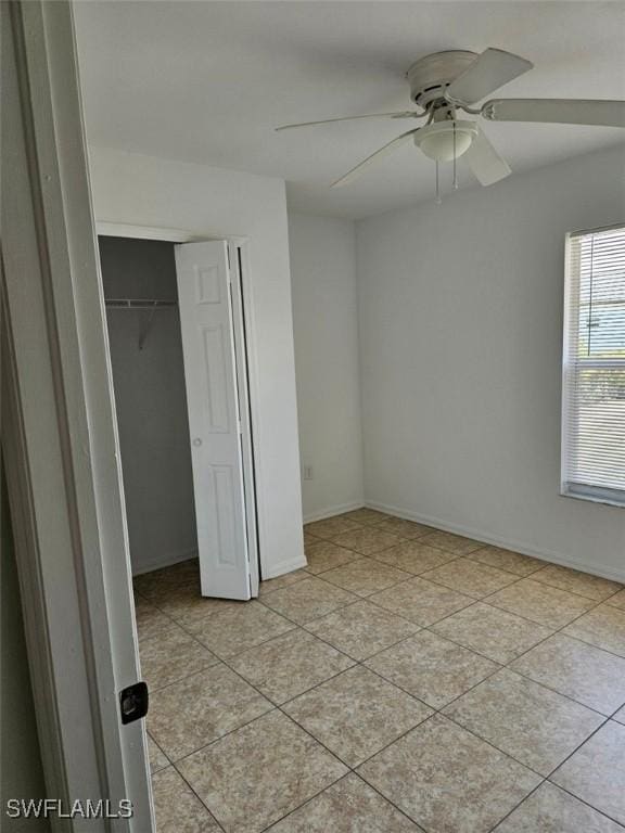 417 NW 18th Pl, Cape Coral, FL 33993 - unfurnished bedroom with a closet, a ceiling fan, baseboards, and light tile patterned flooring