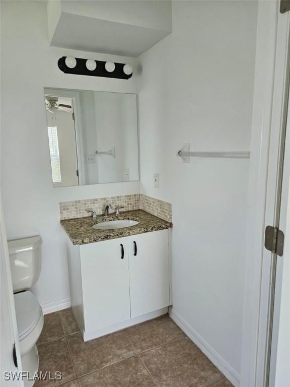 417 NW 18th Pl, Cape Coral, FL 33993 - bathroom with baseboards, toilet, tile patterned flooring, vanity, and tasteful backsplash
