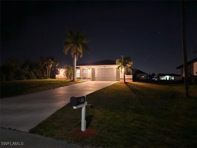 417 NW 18th Pl, Cape Coral, FL 33993 - view of front of home with concrete driveway, a yard, and a garage