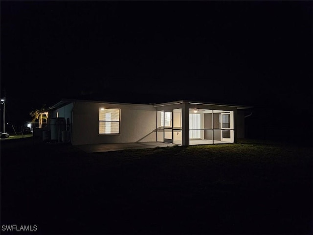 417 NW 18th Pl, Cape Coral, FL 33993 - property exterior at night with a patio area