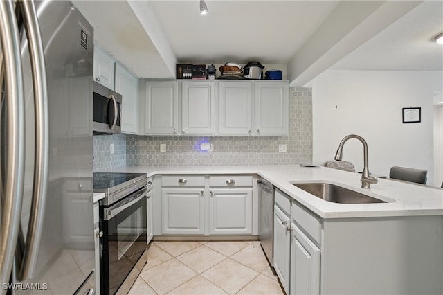 4109 Residence Dr Unit 515, Fort Myers, FL 33901 - kitchen featuring appliances with stainless steel finishes, a sink, a peninsula, light countertops, and backsplash