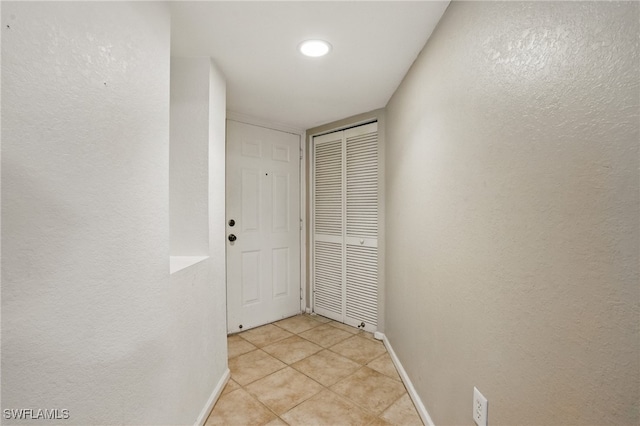 4109 Residence Dr Unit 515, Fort Myers, FL 33901 - entryway featuring light tile patterned floors, baseboards, and a textured wall