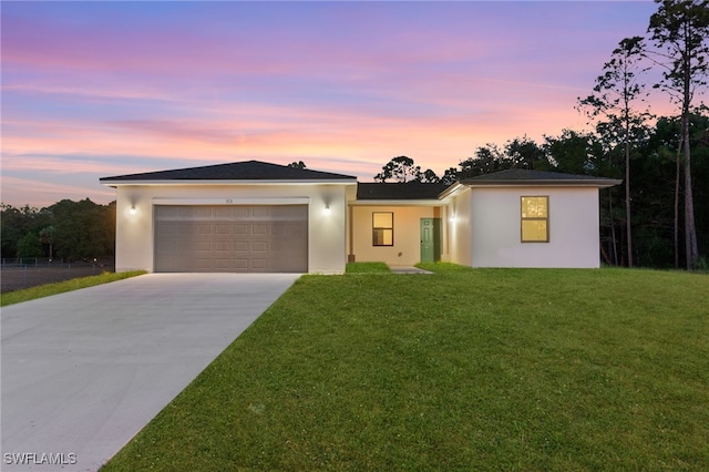 713 Wells Ave, Lehigh Acres, FL 33972 - view of front of property with concrete driveway, a yard, stucco siding, and a garage