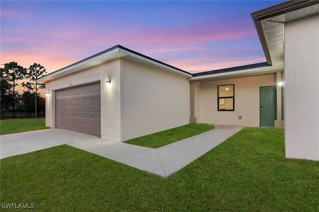 713 Wells Ave, Lehigh Acres, FL 33972 - view of home's exterior with a lawn, driveway, and stucco siding