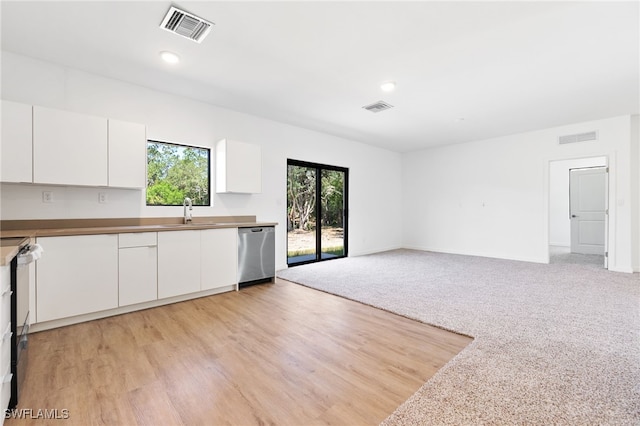 713 Wells Ave, Lehigh Acres, FL 33972 - kitchen featuring stainless steel dishwasher, visible vents, and a healthy amount of sunlight
