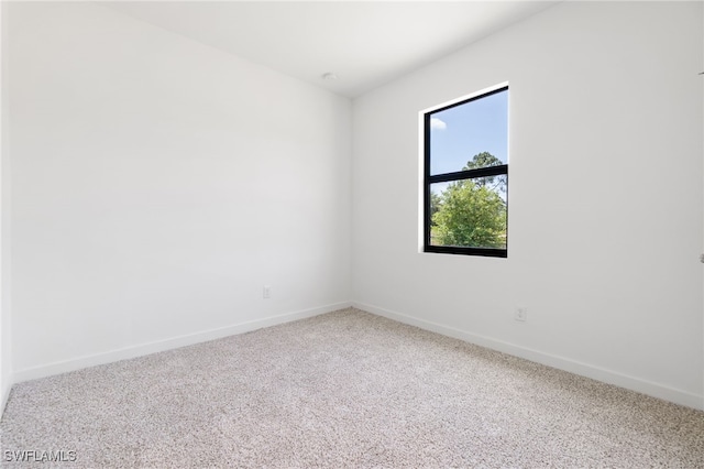 713 Wells Ave, Lehigh Acres, FL 33972 - carpeted spare room featuring baseboards