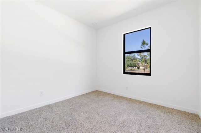 713 Wells Ave, Lehigh Acres, FL 33972 - carpeted spare room with baseboards