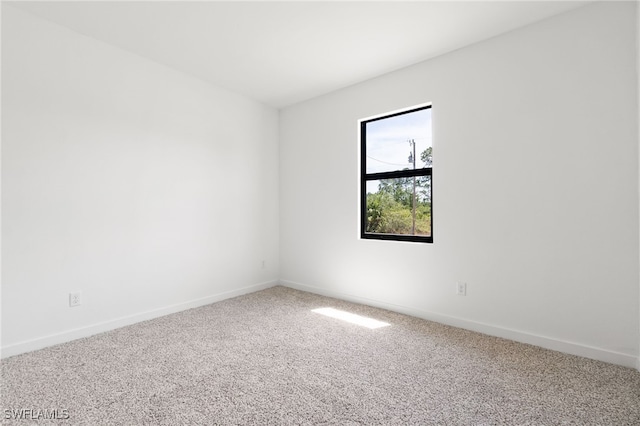 713 Wells Ave, Lehigh Acres, FL 33972 - empty room with baseboards and carpet